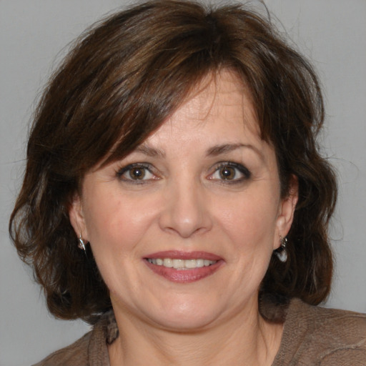 Joyful white adult female with medium  brown hair and brown eyes