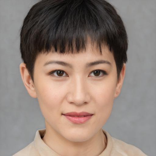 Joyful asian young-adult female with short  brown hair and brown eyes