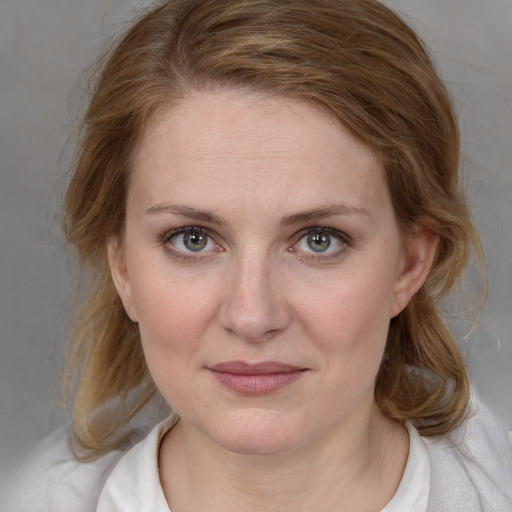 Joyful white young-adult female with medium  brown hair and blue eyes