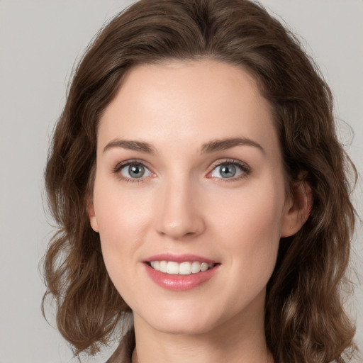 Joyful white young-adult female with medium  brown hair and green eyes