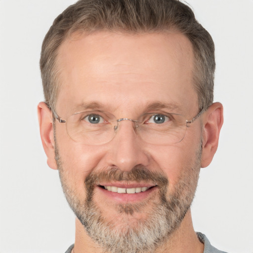 Joyful white middle-aged male with short  brown hair and brown eyes