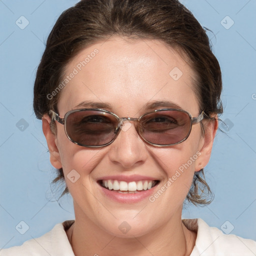 Joyful white young-adult female with medium  brown hair and blue eyes