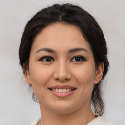 Joyful asian young-adult female with medium  brown hair and brown eyes