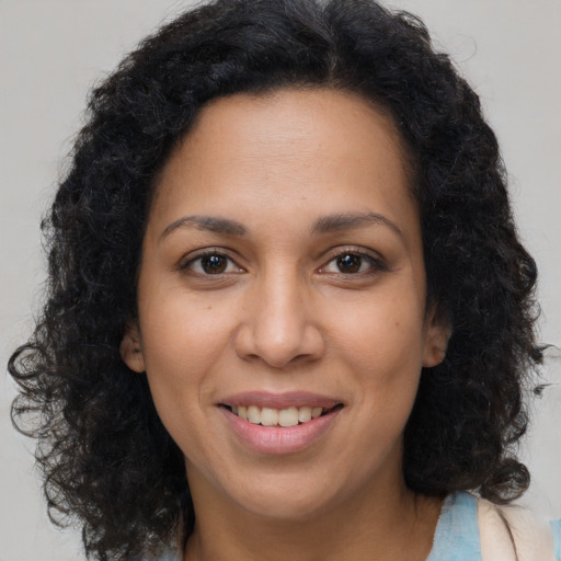 Joyful latino young-adult female with long  brown hair and brown eyes