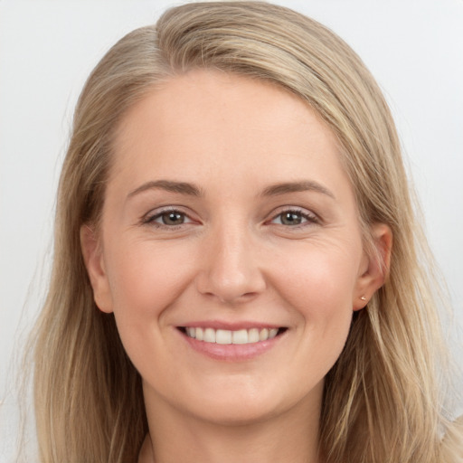 Joyful white young-adult female with long  brown hair and brown eyes