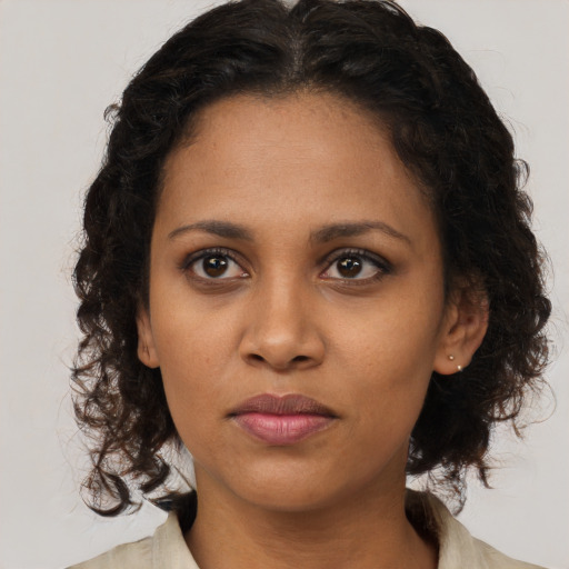 Neutral black young-adult female with medium  brown hair and brown eyes