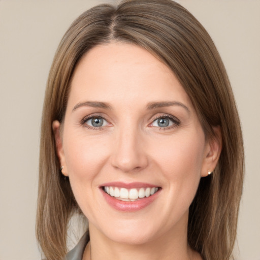 Joyful white young-adult female with long  brown hair and green eyes