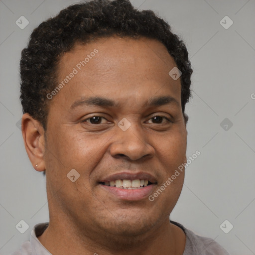 Joyful black adult male with short  brown hair and brown eyes