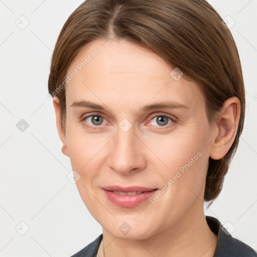 Joyful white young-adult female with medium  brown hair and grey eyes