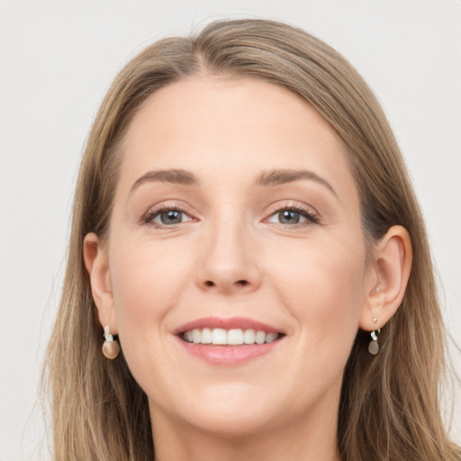 Joyful white young-adult female with long  brown hair and grey eyes