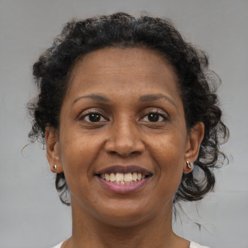Joyful black adult female with short  brown hair and brown eyes