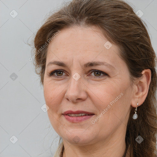 Joyful white adult female with long  brown hair and brown eyes