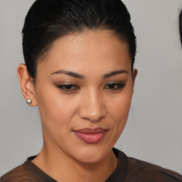 Joyful latino young-adult female with medium  brown hair and brown eyes