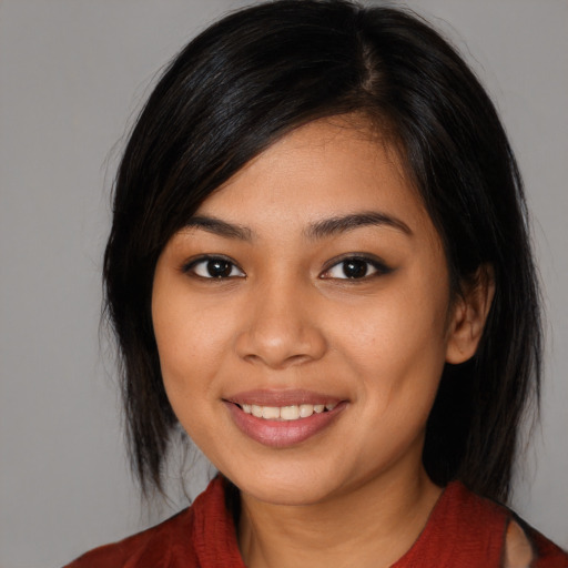 Joyful latino young-adult female with medium  black hair and brown eyes
