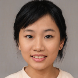 Joyful asian young-adult female with medium  black hair and brown eyes