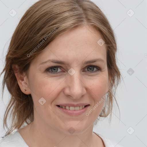 Joyful white adult female with medium  brown hair and grey eyes