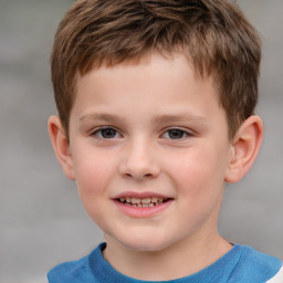 Joyful white child male with short  brown hair and brown eyes