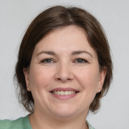 Joyful white adult female with medium  brown hair and brown eyes