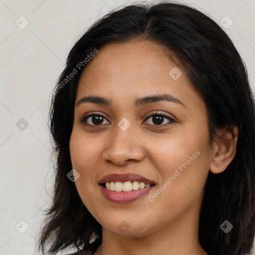 Joyful latino young-adult female with long  brown hair and brown eyes