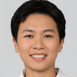 Joyful asian young-adult male with short  black hair and brown eyes