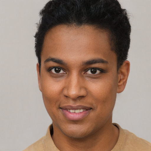 Joyful black young-adult female with short  brown hair and brown eyes