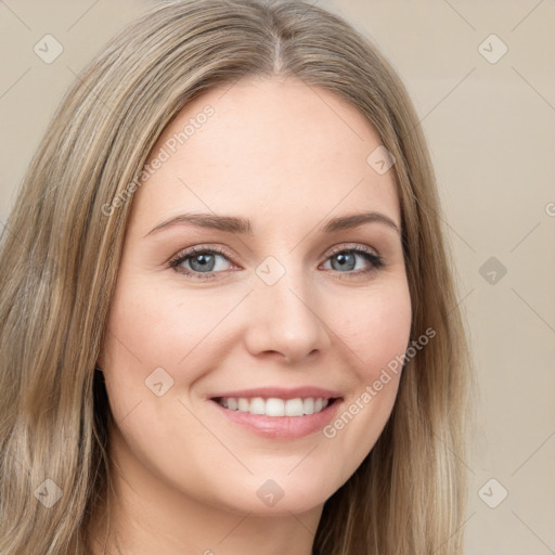 Joyful white young-adult female with long  brown hair and green eyes