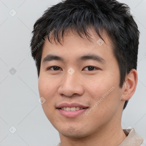 Joyful asian young-adult male with short  brown hair and brown eyes