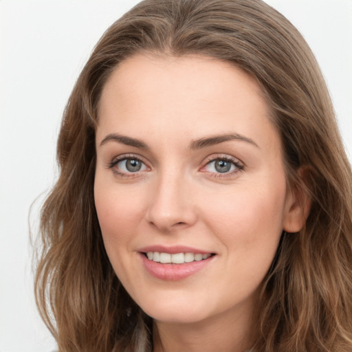 Joyful white young-adult female with long  brown hair and green eyes