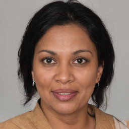 Joyful black adult female with medium  brown hair and brown eyes