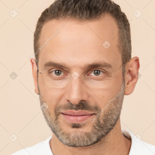 Joyful white adult male with short  brown hair and brown eyes