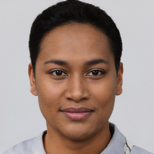 Joyful latino young-adult female with short  black hair and brown eyes
