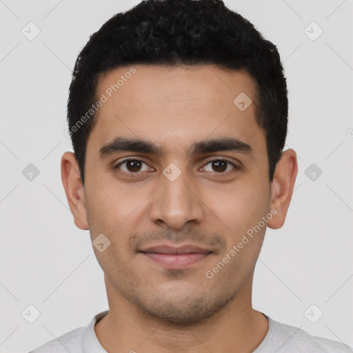 Joyful latino young-adult male with short  black hair and brown eyes