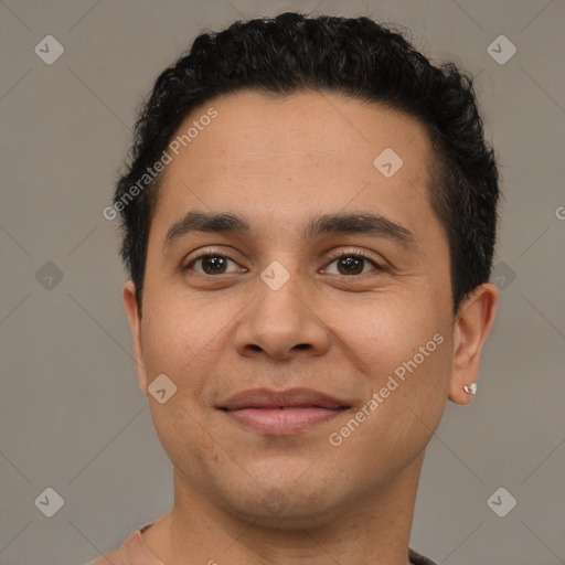 Joyful latino young-adult male with short  brown hair and brown eyes