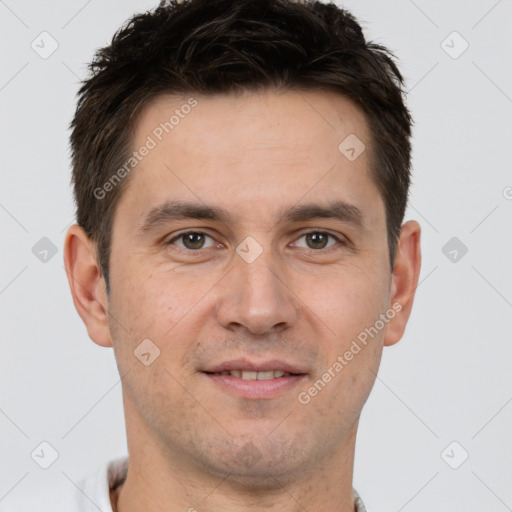 Joyful white adult male with short  brown hair and brown eyes