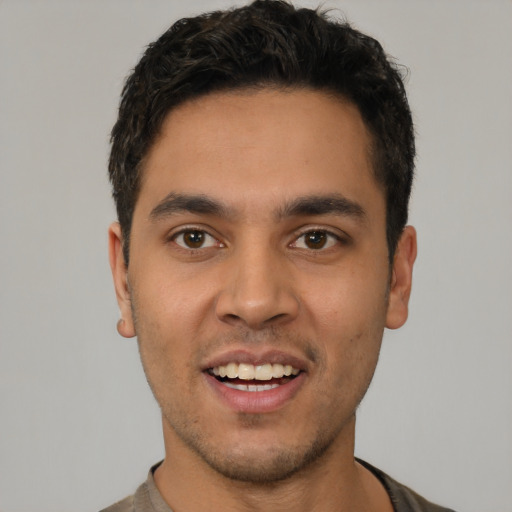 Joyful white young-adult male with short  black hair and brown eyes