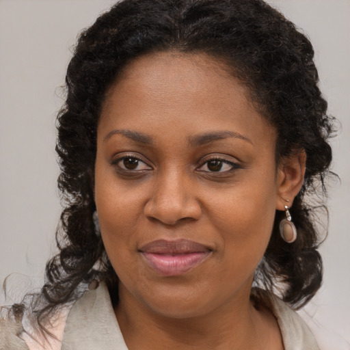 Joyful black young-adult female with medium  brown hair and brown eyes