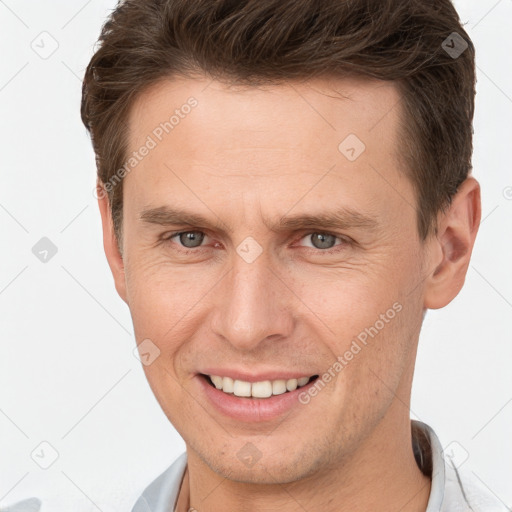 Joyful white adult male with short  brown hair and brown eyes