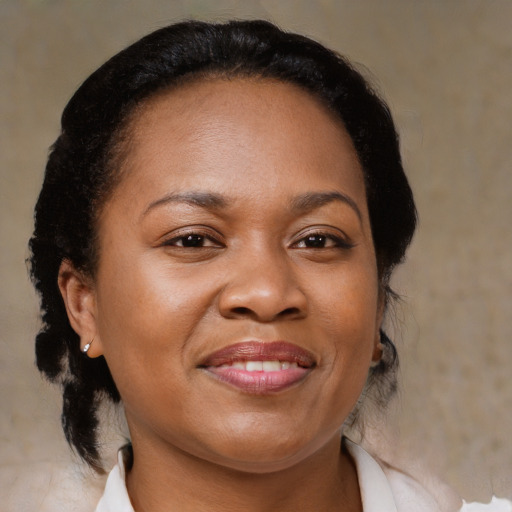 Joyful black adult female with medium  brown hair and brown eyes