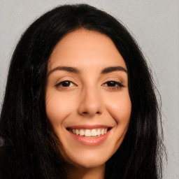 Joyful white young-adult female with long  black hair and brown eyes