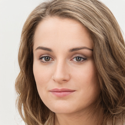 Joyful white young-adult female with long  brown hair and green eyes