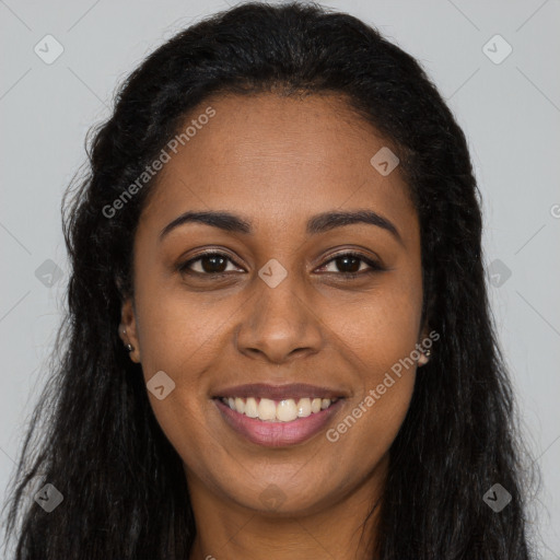 Joyful black young-adult female with long  brown hair and brown eyes