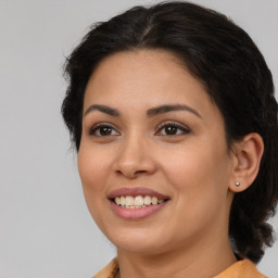 Joyful latino young-adult female with medium  brown hair and brown eyes