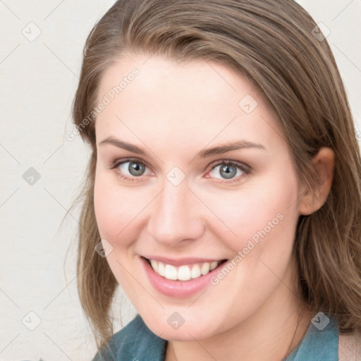 Joyful white young-adult female with medium  brown hair and blue eyes