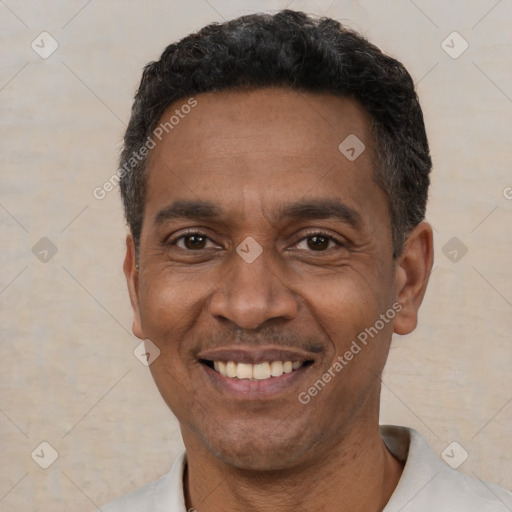 Joyful latino adult male with short  black hair and brown eyes