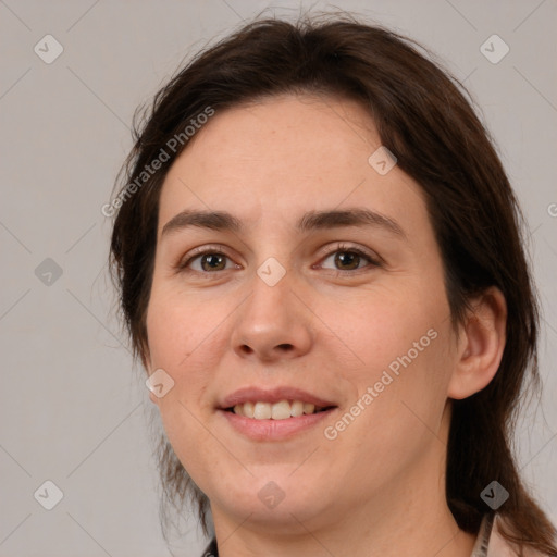 Joyful white adult female with medium  brown hair and brown eyes