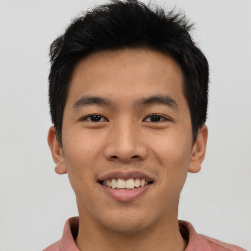 Joyful asian young-adult male with short  black hair and brown eyes