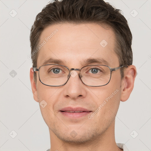 Joyful white adult male with short  brown hair and grey eyes