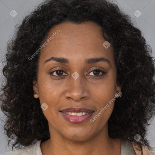 Joyful black adult female with medium  brown hair and brown eyes