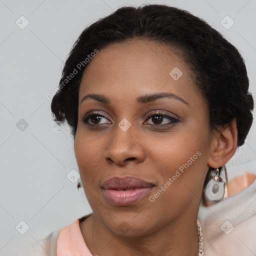 Joyful black young-adult female with long  black hair and brown eyes