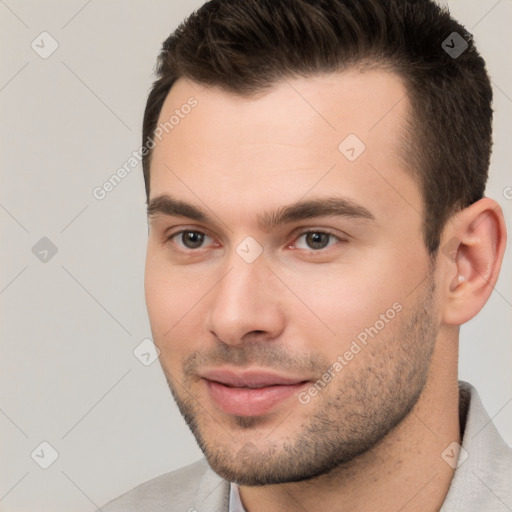 Joyful white young-adult male with short  brown hair and brown eyes